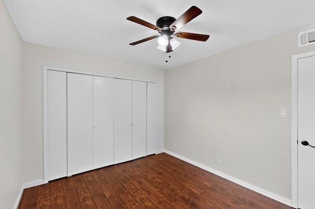 5644 Powers St, The Colony, TX 75056 - unfurnished bedroom featuring dark wood finished floors, a closet, and a ceiling fan