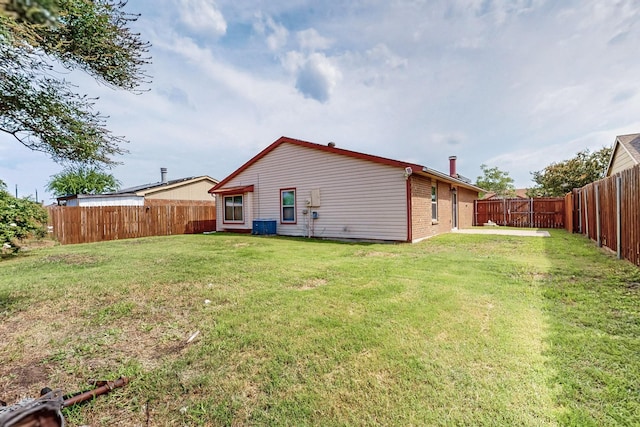 5644 Powers St, The Colony, TX 75056 - back of property featuring a fenced backyard and brick siding