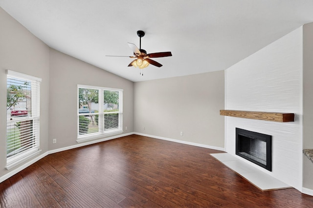 5644 Powers St, The Colony, TX 75056 - unfurnished living room with lofted ceiling, a ceiling fan, dark wood-style floors, and a fireplace with flush hearth