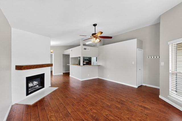 5644 Powers St, The Colony, TX 75056 - unfurnished living room featuring a ceiling fan, a fireplace, dark wood-style flooring, lofted ceiling, and healthy amount of natural light