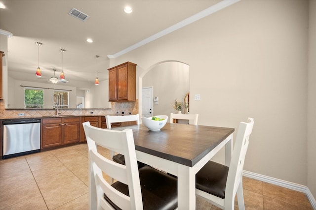 1224 Shelley Dr, Burleson, TX 76028 - dining space featuring light tile patterned floors, crown molding, recessed lighting, ceiling fan, and arched walkways