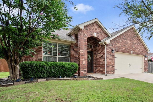 1224 Shelley Dr, Burleson, TX 76028 - view of front facade with a garage, brick siding, driveway, a front lawn, and a shingled roof