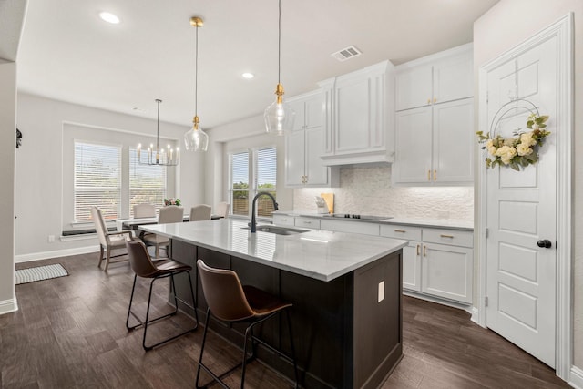 618 Sophia St, Midlothian, TX 76065 - kitchen featuring tasteful backsplash, dark wood-style flooring, white cabinetry, a center island with sink, and recessed lighting