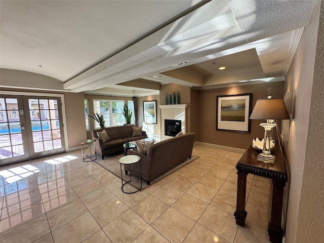 3400 Welborn St Unit 111, Dallas, TX 75219 - living room with french doors, light tile patterned floors, vaulted ceiling, ornamental molding, and a glass covered fireplace