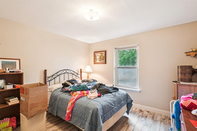 406 Anice Ln, Euless, TX 76039 - bedroom featuring wood finished floors and baseboards