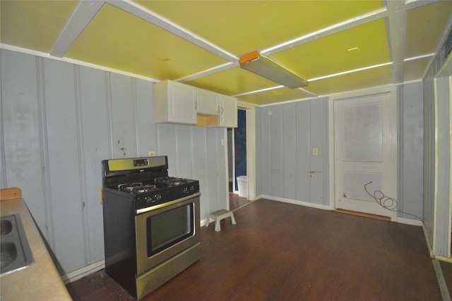214 Fenton St, Waco, TX 76705 - kitchen featuring stainless steel gas range oven, a decorative wall, white cabinetry, and dark wood finished floors