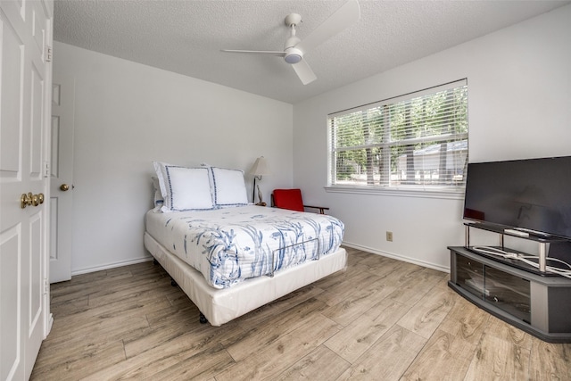 162 Aztec Dr, Mabank, TX 75156 - bedroom with wood finished floors, a textured ceiling, and a ceiling fan