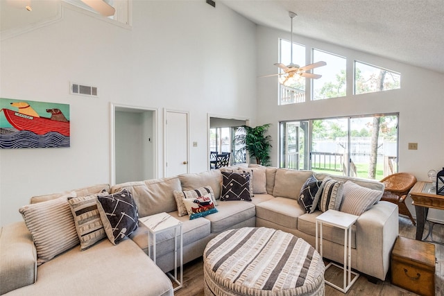 162 Aztec Dr, Mabank, TX 75156 - living room with ceiling fan, wood finished floors, high vaulted ceiling, and a textured ceiling