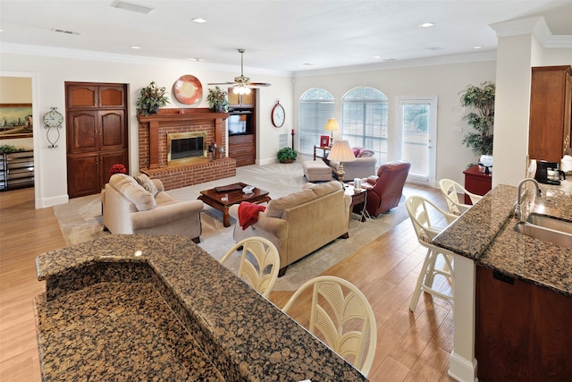 128 Country Club Dr, Heath, TX 75032 - living room with ceiling fan, light wood-style floors, a fireplace, ornamental molding, and recessed lighting