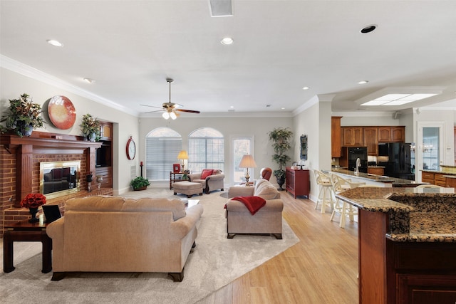 128 Country Club Dr, Heath, TX 75032 - living room with light wood finished floors, a ceiling fan, ornamental molding, a brick fireplace, and recessed lighting