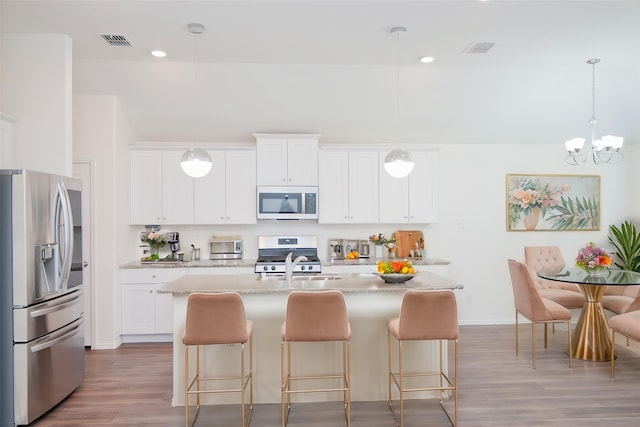 3913 Great Plains Way, Forney, TX 75126 - kitchen featuring stainless steel appliances, light wood-type flooring, a kitchen bar, and recessed lighting