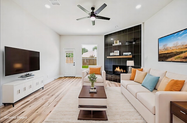 15578 Wrangler Dr, Frisco, TX 75035 - living room with light wood-type flooring, ceiling fan, recessed lighting, and a tile fireplace