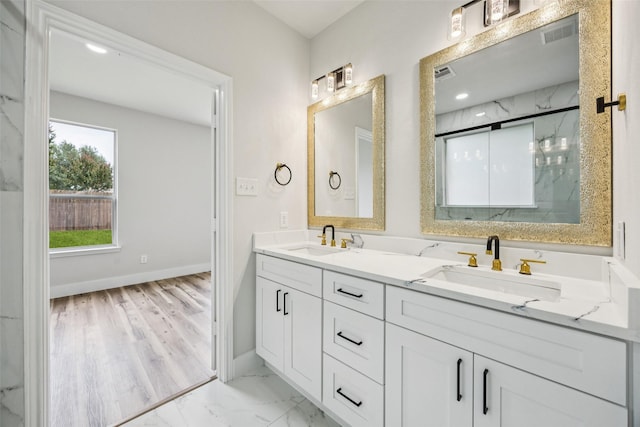 15578 Wrangler Dr, Frisco, TX 75035 - bathroom featuring double vanity, a marble finish shower, and marble look tiles