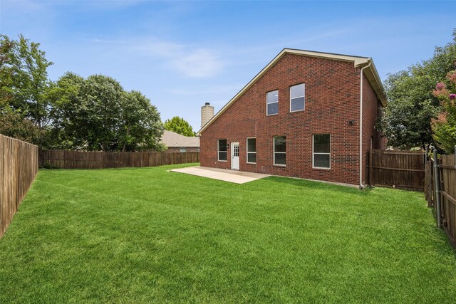 15578 Wrangler Dr, Frisco, TX 75035 - rear view of property featuring brick siding, a patio area, a fenced backyard, and a chimney