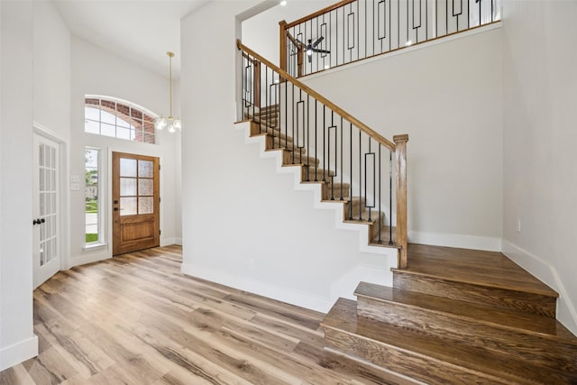 15578 Wrangler Dr, Frisco, TX 75035 - foyer featuring a high ceiling, stairs, wood finished floors, and french doors
