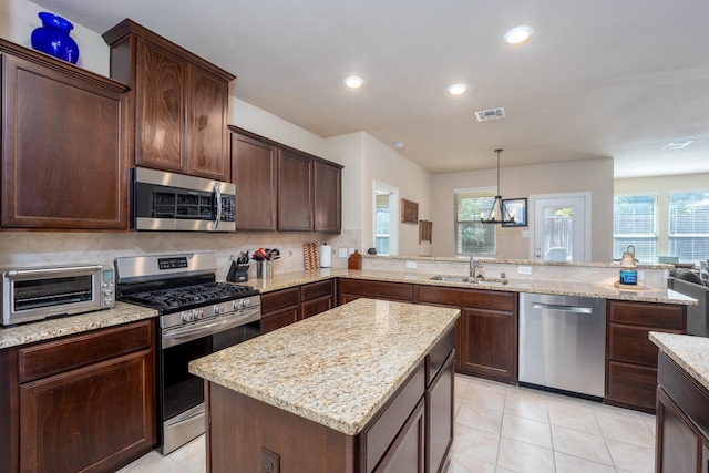 3508 Cooke Ln, Melissa, TX 75454 - kitchen featuring stainless steel appliances, light stone countertops, dark brown cabinets, recessed lighting, and decorative backsplash