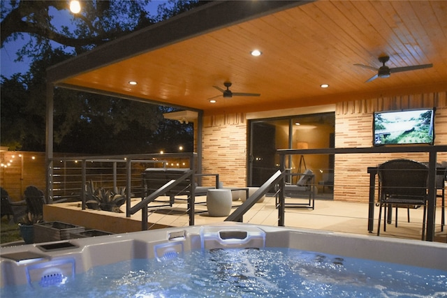 2542 Woodmere Dr, Dallas, TX 75233 - pool at night with a ceiling fan and a hot tub