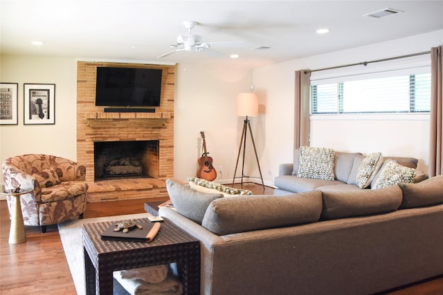 2542 Woodmere Dr, Dallas, TX 75233 - living area with wood finished floors, a ceiling fan, a fireplace, and recessed lighting