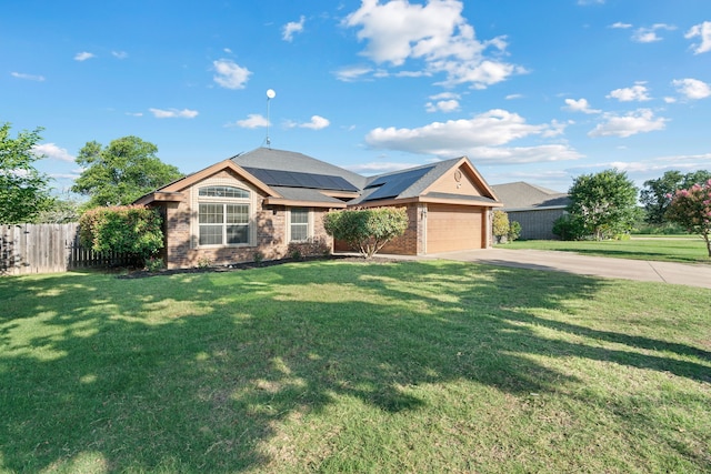 110 Westwood Ct, Cisco, TX 76437 - ranch-style home with concrete driveway, roof mounted solar panels, an attached garage, and brick siding