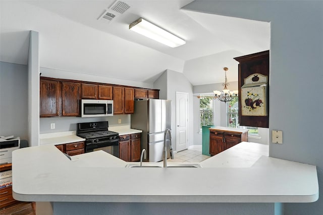 9212 Bedford Ln, Mckinney, TX 75071 - kitchen featuring stainless steel appliances, vaulted ceiling, light countertops, a chandelier, and pendant lighting