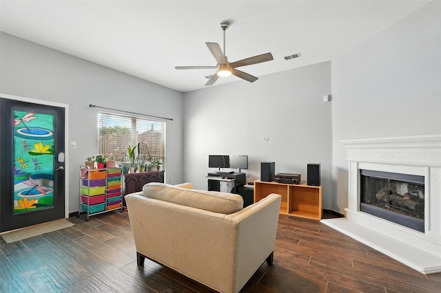 9212 Bedford Ln, Mckinney, TX 75071 - living area featuring a ceiling fan, dark wood-type flooring, a fireplace with raised hearth, and an office area