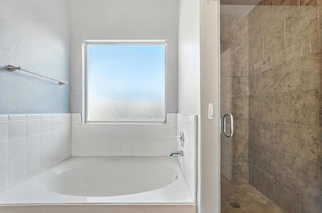 9212 Bedford Ln, Mckinney, TX 75071 - full bathroom featuring a textured wall, a bath, and a shower stall