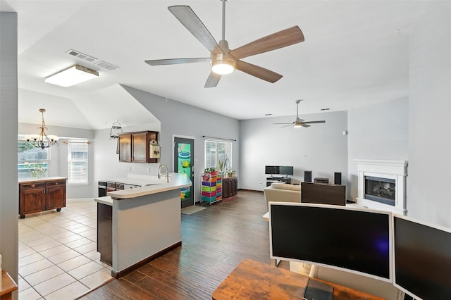 9212 Bedford Ln, Mckinney, TX 75071 - kitchen with healthy amount of natural light, a peninsula, light countertops, a chandelier, and lofted ceiling