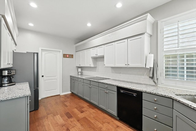 4321 Hazy Meadow Ln, Grapevine, TX 76051 - kitchen featuring gray cabinets, black appliances, tasteful backsplash, light wood-style flooring, and recessed lighting