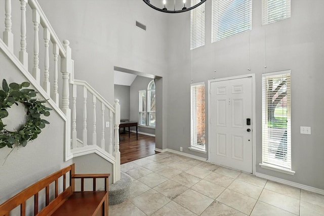 4321 Hazy Meadow Ln, Grapevine, TX 76051 - tiled foyer entrance featuring stairs, a towering ceiling, and a chandelier