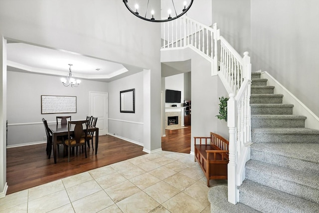 4321 Hazy Meadow Ln, Grapevine, TX 76051 - dining area with a chandelier, tile patterned floors, stairs, and a fireplace with flush hearth