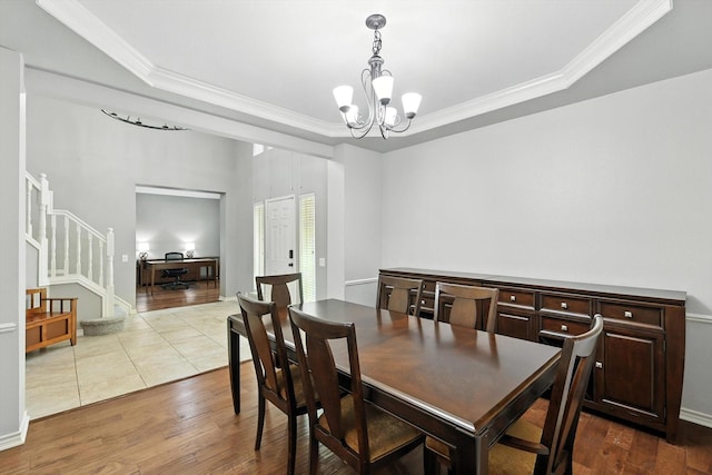 4321 Hazy Meadow Ln, Grapevine, TX 76051 - dining area featuring ornamental molding, a chandelier, dark wood-type flooring, a raised ceiling, and stairway