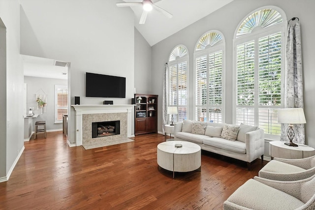 4321 Hazy Meadow Ln, Grapevine, TX 76051 - living room with high vaulted ceiling, ceiling fan, healthy amount of natural light, dark wood-style flooring, and a tile fireplace