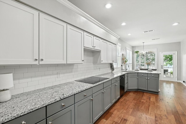 4321 Hazy Meadow Ln, Grapevine, TX 76051 - kitchen with black electric stovetop, gray cabinetry, wood finished floors, a peninsula, and recessed lighting