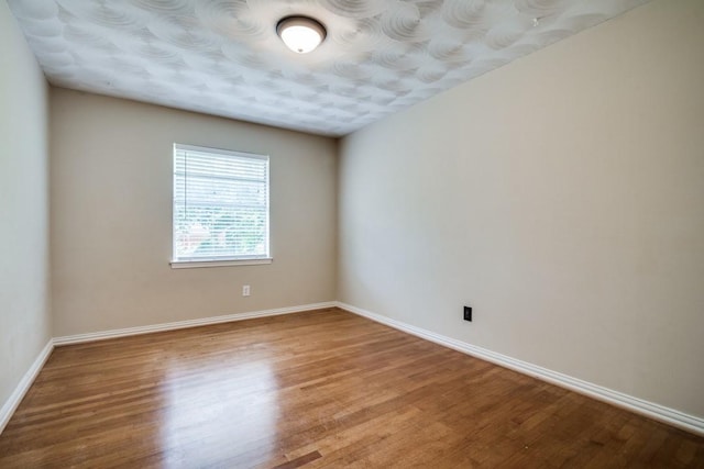 4737 Lawler Rd, Garland, TX 75042 - spare room featuring wood finished floors and baseboards