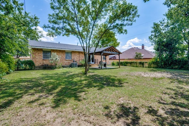 4737 Lawler Rd, Garland, TX 75042 - rear view of house with brick siding, a lawn, a gazebo, and a patio area