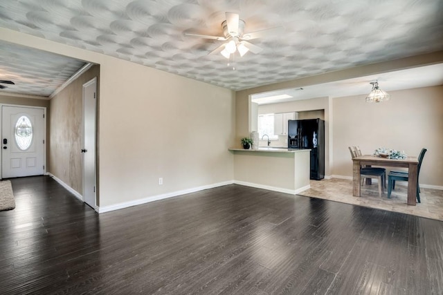 4737 Lawler Rd, Garland, TX 75042 - unfurnished living room with ceiling fan, wood finished floors, and a chandelier