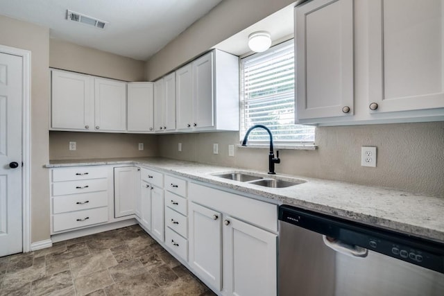 4737 Lawler Rd, Garland, TX 75042 - kitchen with stainless steel dishwasher, white cabinets, stone finish flooring, and light stone countertops