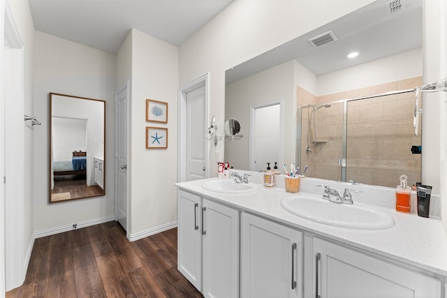 4917 Woodloch Dr, Princeton, TX 75407 - full bath with connected bathroom, wood finished floors, a stall shower, and double vanity