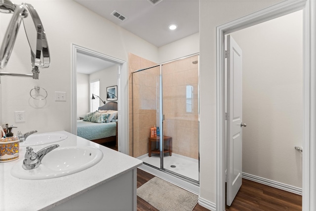 4917 Woodloch Dr, Princeton, TX 75407 - full bath with wood finished floors, a shower stall, and double vanity