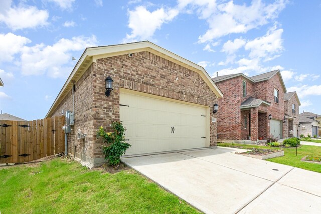 1103 Witherspoon Ln, Princeton, TX 75407 - view of front of home featuring driveway, a gate, a garage, and brick siding