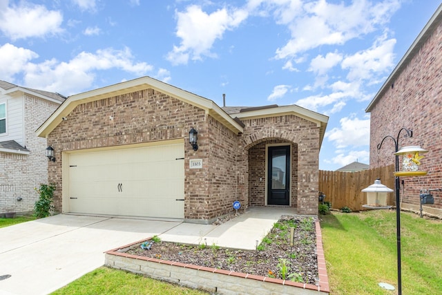1103 Witherspoon Ln, Princeton, TX 75407 - view of front of home with brick siding, an attached garage, and concrete driveway