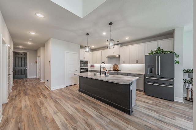 2420 Stella Ln, Northlake, TX 76247 - kitchen featuring stainless steel appliances, white cabinetry, recessed lighting, light wood-style flooring, and a kitchen island with sink
