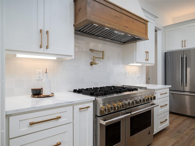 16652 Caeli Heights Ct, Winona, TX 75792 - kitchen featuring appliances with stainless steel finishes, custom range hood, white cabinets, and backsplash