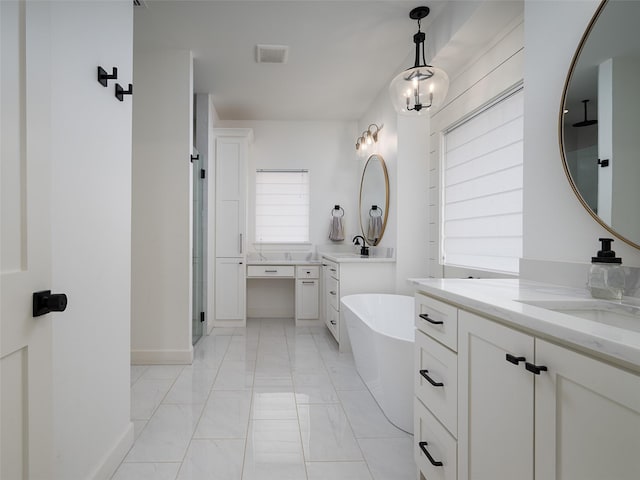 16652 Caeli Heights Ct, Winona, TX 75792 - bathroom with two vanities, a freestanding bath, marble finish flooring, and a walk in shower