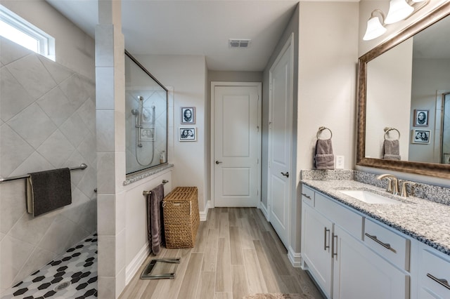 1116 Cornerstone Dr, Little Elm, TX 76227 - bathroom featuring vanity, a walk in shower, and wood finished floors
