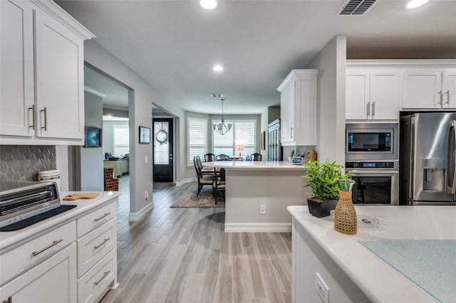 1116 Cornerstone Dr, Little Elm, TX 76227 - kitchen featuring appliances with stainless steel finishes, light countertops, white cabinets, recessed lighting, and backsplash
