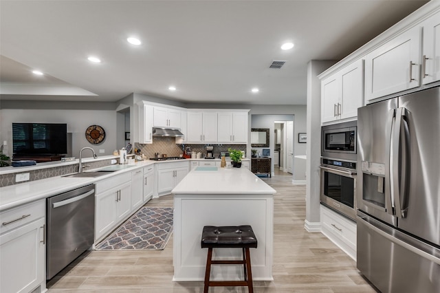 1116 Cornerstone Dr, Little Elm, TX 76227 - kitchen featuring stainless steel appliances, recessed lighting, decorative backsplash, white cabinets, and a kitchen island