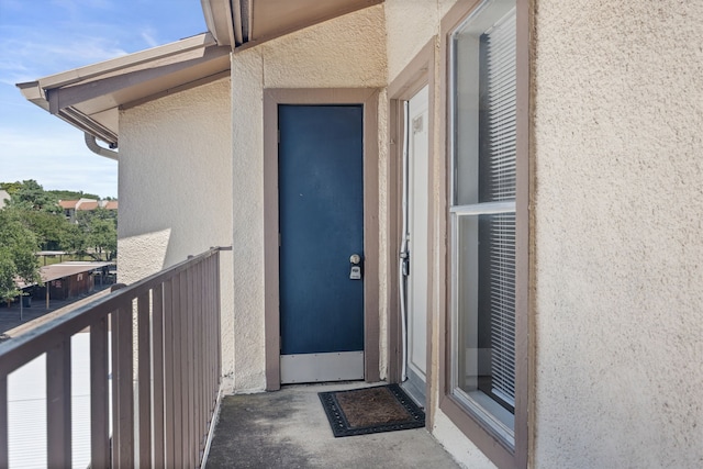 6050 Melody Ln Unit 341, Dallas, TX 75231 - doorway to property with stucco siding and a balcony