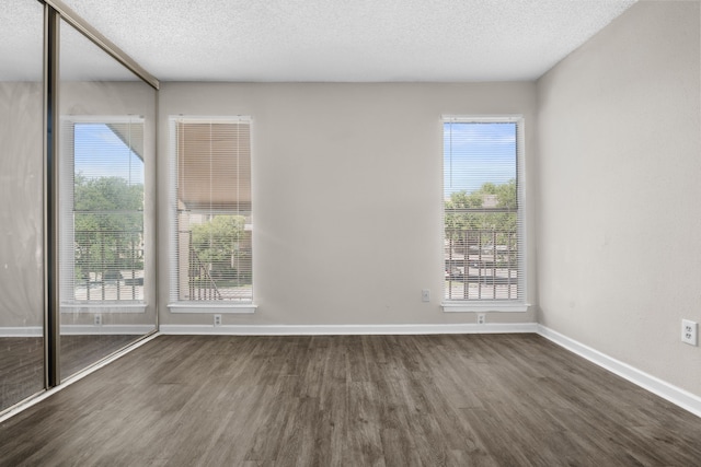 6050 Melody Ln Unit 341, Dallas, TX 75231 - unfurnished room with dark wood-style floors and a textured ceiling