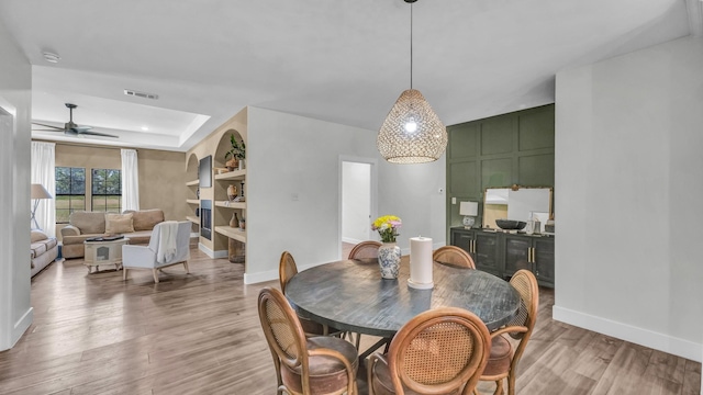 1381 County Road 1470, Chico, TX 76431 - dining room with light wood finished floors, a ceiling fan, and a tray ceiling